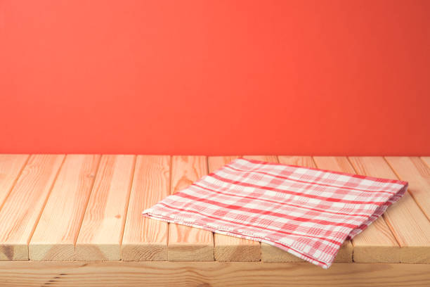 istock Christmas empty wooden table with tablecloth over red festive background 1179176764