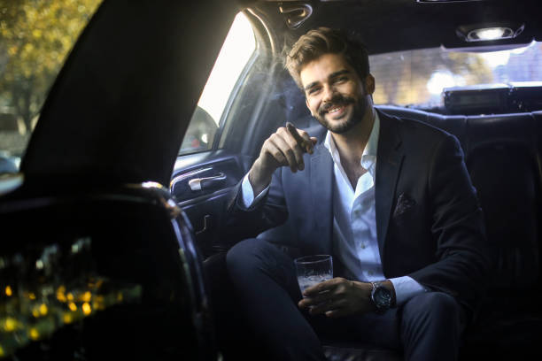 istock Smiling businessman in a limousine 1179177702