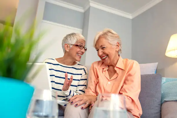 Photo of Two old women and laptop.