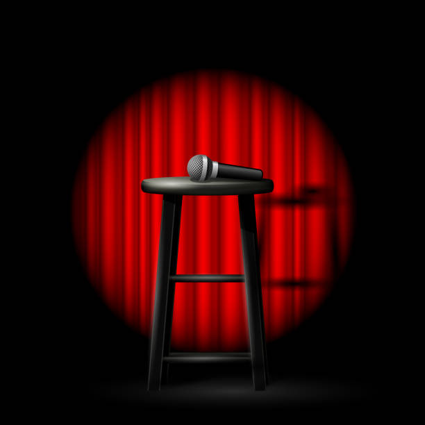 Stand up comedy show - microphone and stool in ray of spotlight and drop-curtain Stand up comedy show - microphone and stool in ray of spotlight and drop-curtain stage performance space stock illustrations