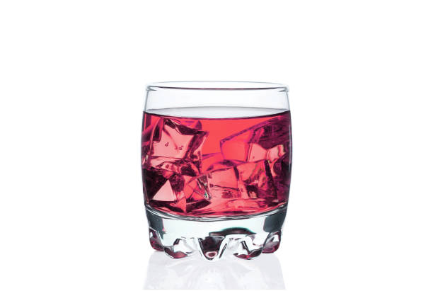 istock Glass with ice cubes, chilled drink bar, energy drink, colored liquid, isolate white background. 1179179420