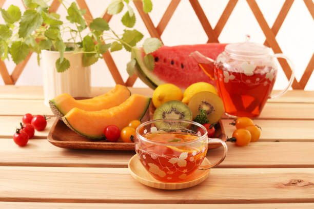 A cup of tea and fresh fruits on the dining table