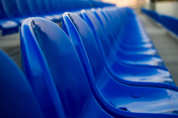 istock Blue plastic chairs in line for funs in sports stadium 1179180755