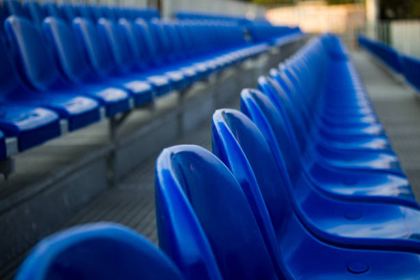istock Blue plastic chairs in line for funs in sports stadium 1179180761