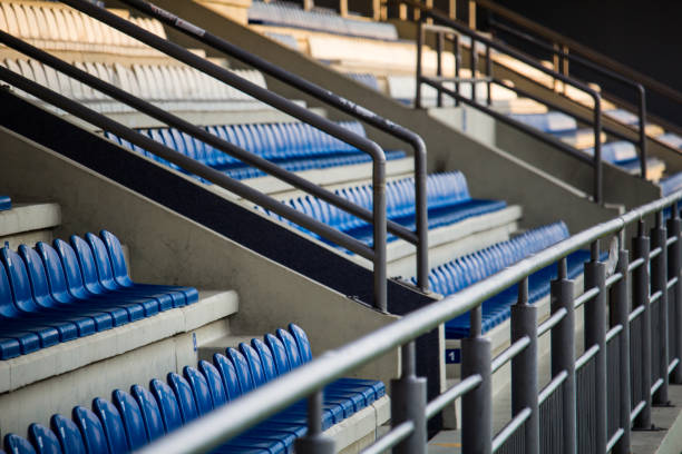 istock White and blue plastic chairs in row in sports stadium 1179182059