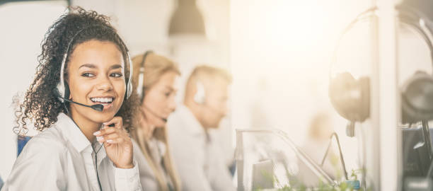 call center worker accompanied by her team. - african descent customer service representative computer service imagens e fotografias de stock