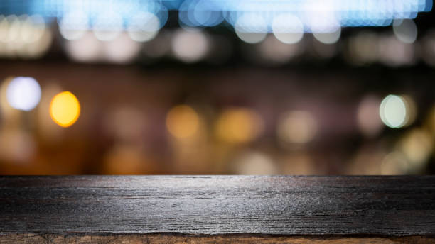 istock Empty wooden table platform and bokeh at night 1179185369