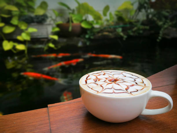 istock white cup for Late Art coffee. Blur fancy carp pool background 1179186568