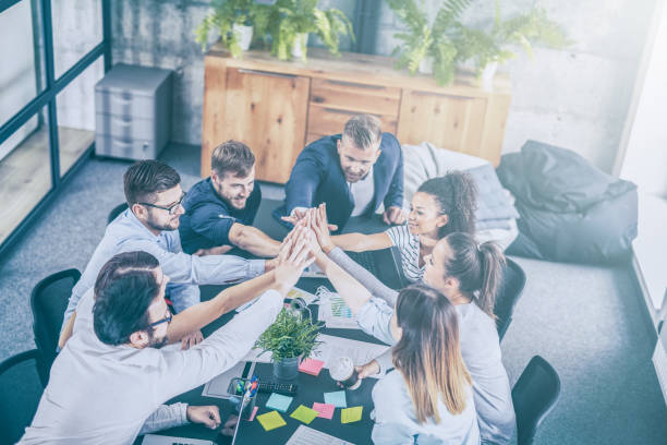 istock Happy business people team giving high five in office. 1179187665