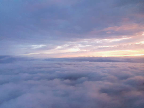 istock View from airplane window inside the clouds with colorful sunrise 1179188218