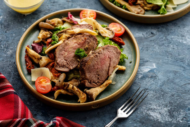 istock Salad with warm beef with oyster mushrooms, tomatoes and greens. 1179190833