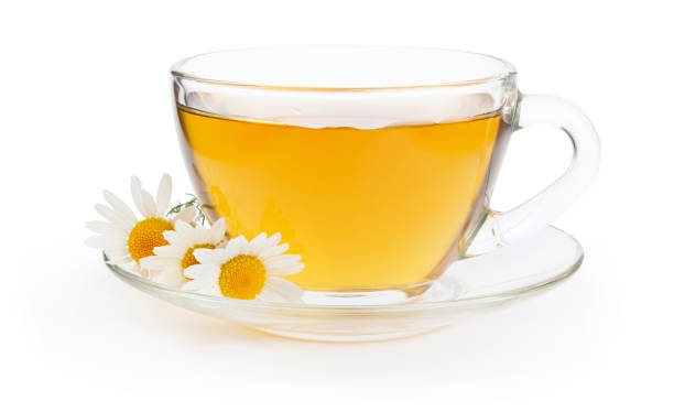 istock Cup of hot herbal chamomile tea with flowers on white background 1179191678