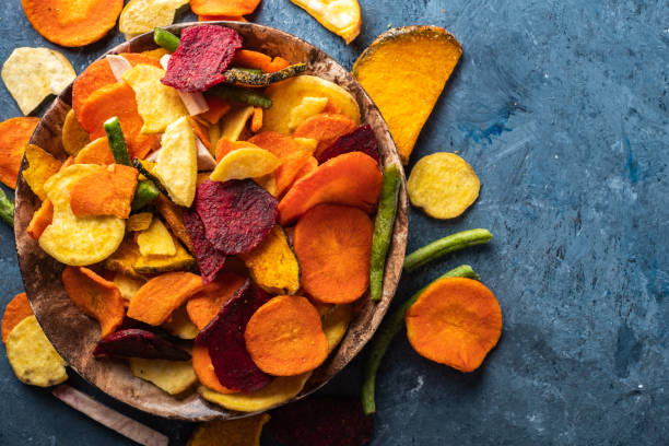 istock Dried vegetables chips from carrot, beet, parsnip and other vegetables on blue backgrounds. Organic diet and vegan food 1179192217