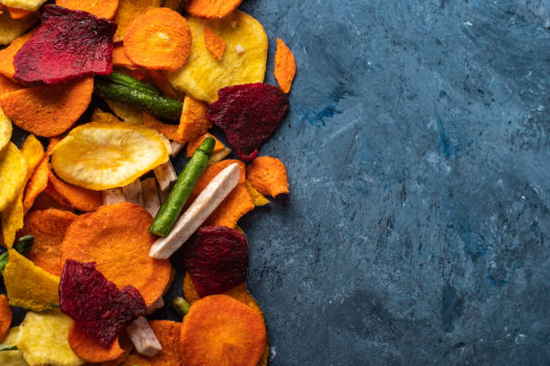 istock Dried vegetables chips from carrot, beet, parsnip and other vegetables on blue backgrounds. Organic diet and vegan food 1179192389