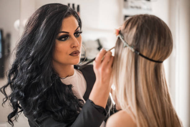 istock Professional make-up artist applying makeup on a model 1179193009
