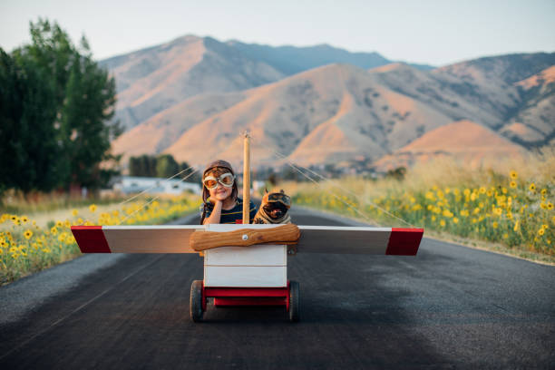 istock Boy Flying in Toy Airplane with Pet Dog 1179193110