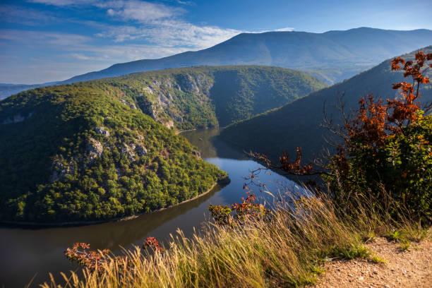 istock River surrounded by the hills and mountains 1179194430