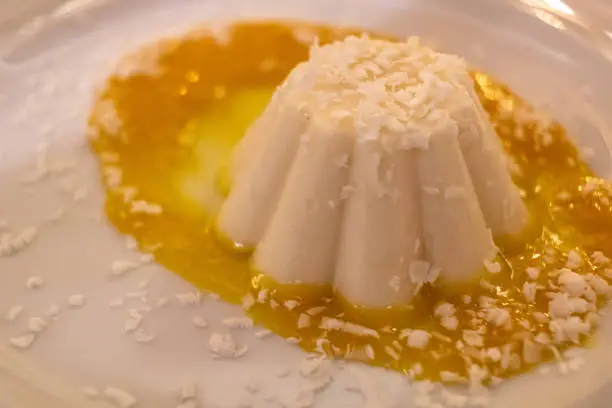 coconut pudding with mango syrup