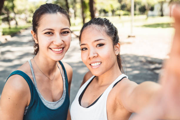 istock Young women taking a selfie together at the park while jogging 1179196640