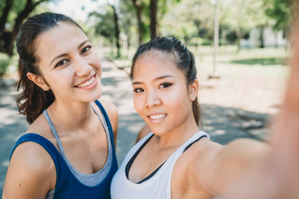 istock Young women taking a selfie together at the park while jogging 1179196644
