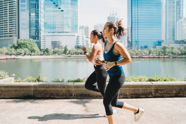 istock Young women running together at the park 1179196663