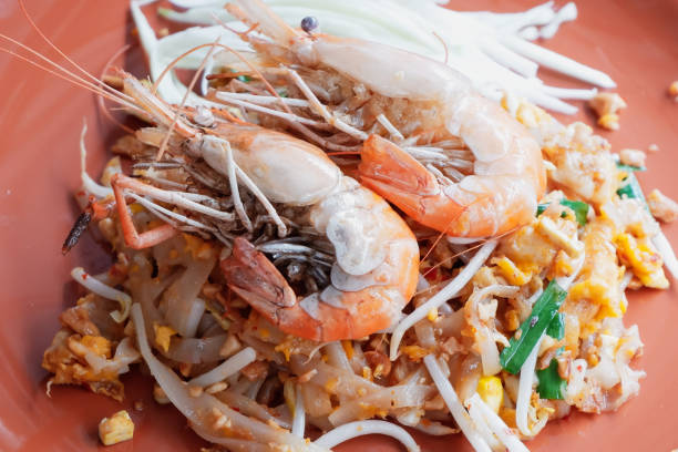istock Pad Thai with fresh prawns in an orange plate 1179196702