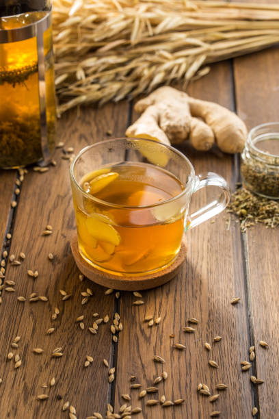 istock Cup of ginger tea with lemon and wheat spike on wooden table 1179199859