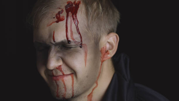 istock Halloween man portrait. Guy with dripping blood on his face. Scary makeup 1179201500