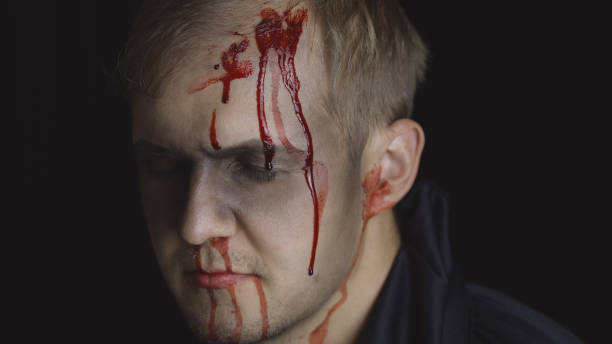 istock Halloween man portrait. Guy with dripping blood on his face. Scary makeup 1179201503