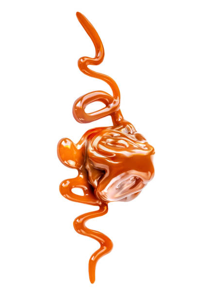 istock Caramel candie with sauce  isolated on  white background. Caramel splashes, top view 1179207294
