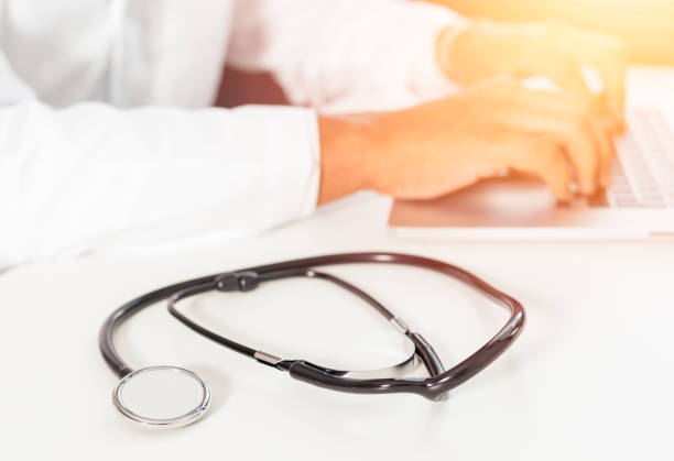 istock defocused image of a doctor working with laptop computer in medical workspace office as concept with stethoscope on foreground and sunlight 1179209817