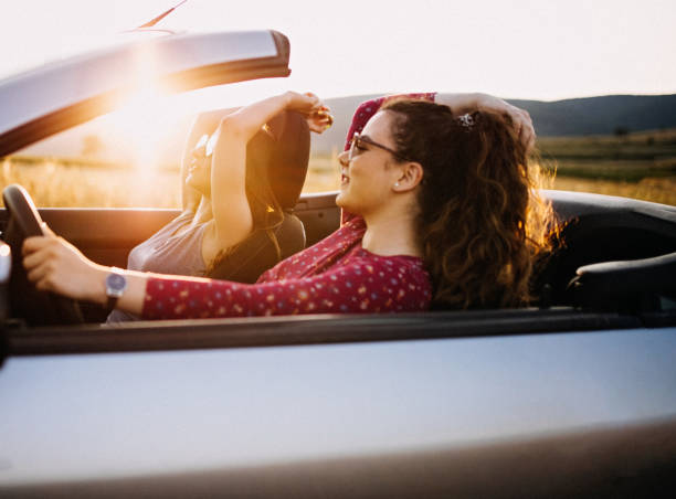 istock Young women having fun in convertible e at sunset 1179209992
