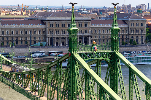 Budapest Hungary-July. 25, 2019: Liberty Bridge over the Danube in Budapest. Cruise ship terminal by the bank. The bridge connecting Buda and Pest across the River Danube.