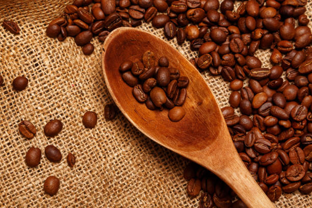 istock Coffee beans and wooden spoon 1179217787