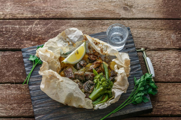 istock Lamb kleftiko, potato and vegetables served on wooden cutin board, rustic style 1179218051