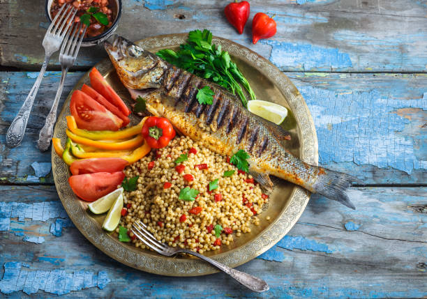 istock Grilled sea bass on coper plate, moroccan style, copy space 1179223513