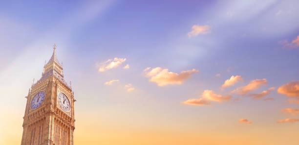 istock Big Ben Clock Tower in London on a sunset. Panoramic toned image in orange and light purple with copy-space 1179232539