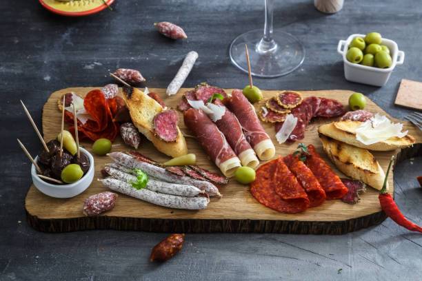 istock Typical spanish tapas concept. include variety slices jamon, chorizo, salami, bowls with olives, peppers. Copyspace. 1179235231