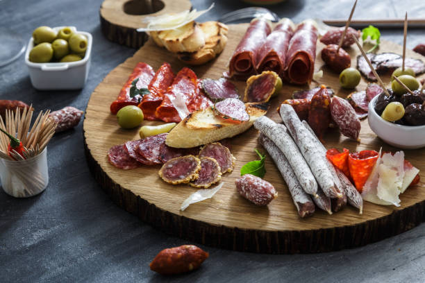 istock Typical spanish tapas concept. include variety slices jamon, chorizo, salami, bowls with olives, peppers. Copyspace. 1179235294