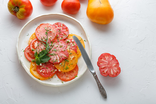 Tomato sliced on a plate. Top view
