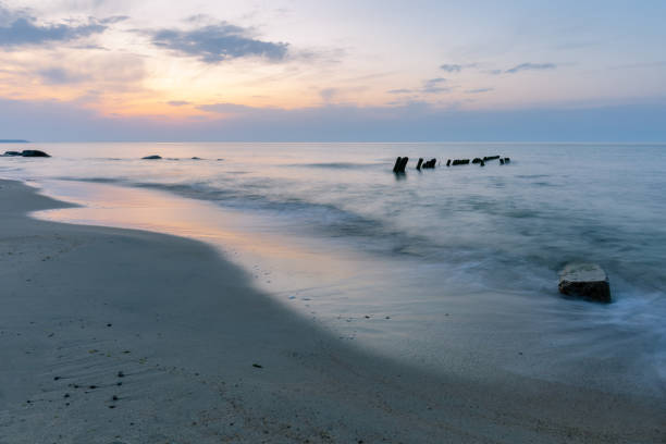 istock long exposure sea surface with protruding breakwaters during sunset 1179241572