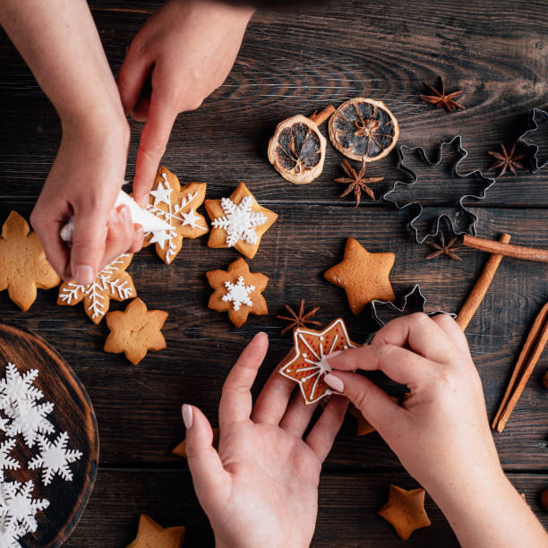 istock Friends decorating christmas gingerbread cookies 1179245409