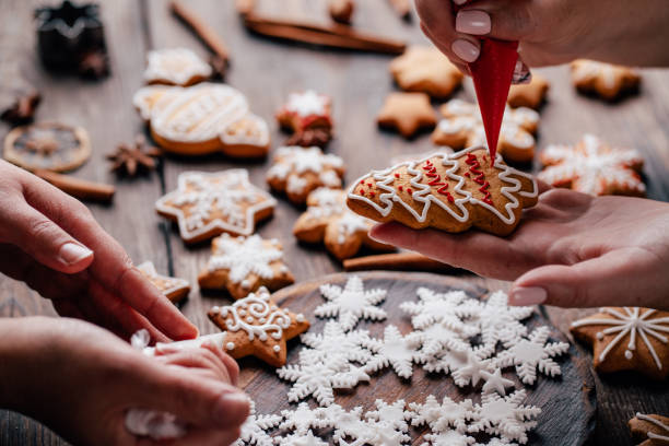 istock Friends decorating christmas gingerbread cookies 1179245410