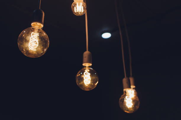 istock light bulb Edison filament retro vintage decor on brick wall background. Lighting decoration. 1179251843