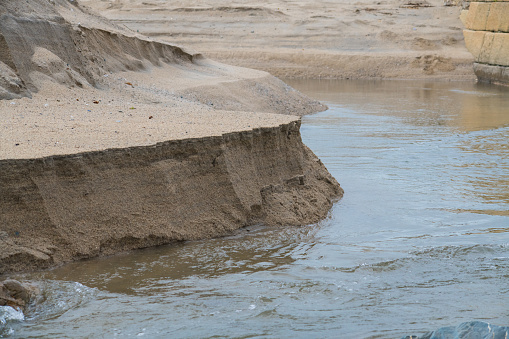 Tidal erosion of a sandback in Pentewan, Cornwall