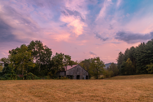Early autumn sunset over an old wooden barn near Hot Springs, North Carolina, close to the Tennessee border