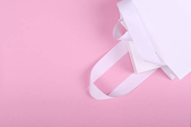 istock White gift box in white gift bag on pink background 1179261113