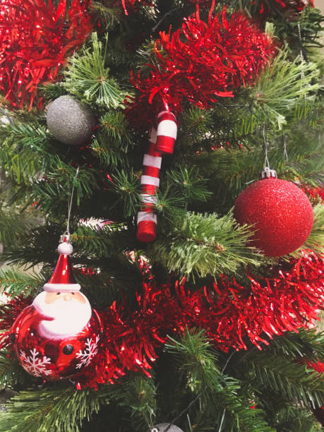 istock Christmas tree and gold orange shiny balls decorations on pine tree event background light up close up ornament xmas 1179261215