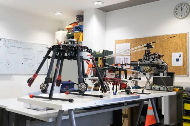 Research and development drone laboratory. View of an indoor workshop with multiple kinds of UAV