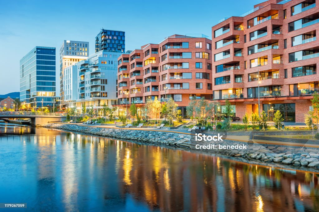 New residential district with condos in downtown Oslo Norway Stock photograph of a new residential district with condo buildings in downtown Oslo Norway at twilight blue hour. Building Exterior Stock Photo